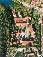 Luftbild von Kloster und tiefem See.